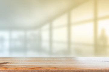 Canvas Print - wooden desk with blurred of interior office room with city building background