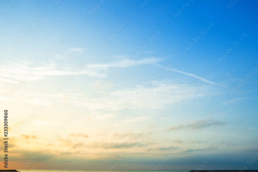 Beautiful early morning sunrise over the sea the horizon,blue sky background texture with white clouds sunset. - obrazy, fototapety, plakaty 