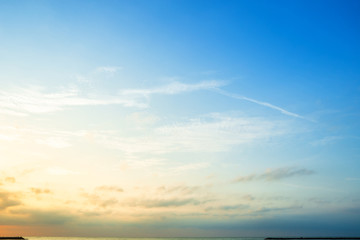 beautiful early morning sunrise over the sea the horizon,blue sky background texture with white clou