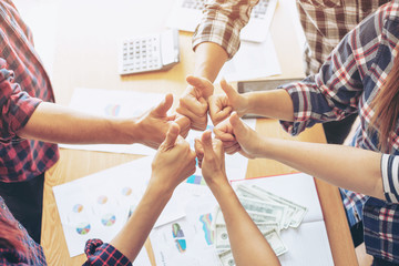 Wall Mural - close up hand of business  people bump hands thumb up finishing up meeting showing unity , business teamwork concept