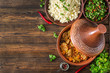 Traditional tajine dishes, couscous  and fresh salad  on rustic wooden table. Tagine lamb meat and pumpkin. Top view. Flat lay