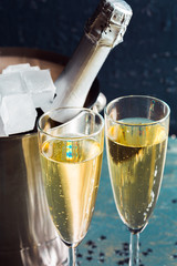 Wall Mural - Champagne bottle in bucket with ice and glasses of champagne