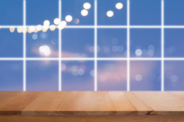 Canvas Print - wooden desk with blurred light on road in city with bokeh abstract background