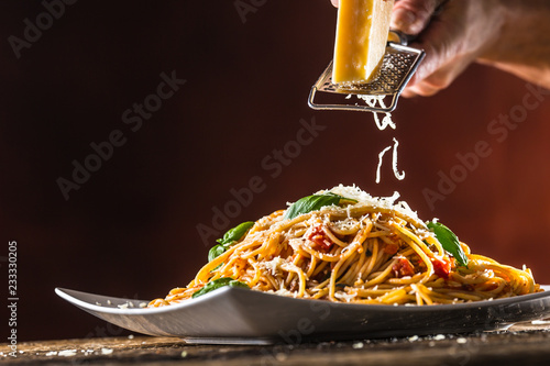 Cuadros en Lienzo Italian pasta spaghetti with tomato sauce basil and parmesan cheese in white pla