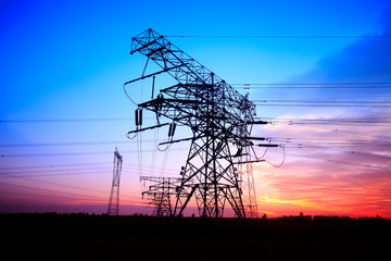 In the evening, the silhouette of high voltage towers