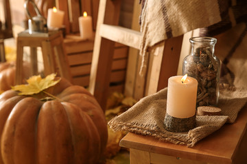 Wall Mural - Burning candle on wooden table in room