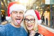 Couple shopping on Christmas time taking a funny selfie