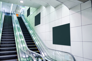 Wall Mural - Public escalator with blank billboard on wall