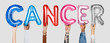 © Rawpixel.com - Hands showing cancer balloons word
