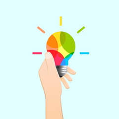 Wall Mural - hand holding colorful light bulb as creativity and idea concept