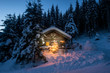 © Westend61 - Illuminated wooden house with snowman and Christmas tree on snowy landscape