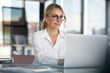 © Westend61 - Businesswoman working in office, using laptop