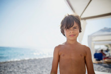 Portrait Of Tanned Boy On The Beach