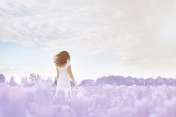 girl dancing in a field of purple flowers