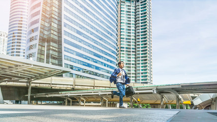 Wall Mural - portrait of business man run with laptop briefcase at outdoor pedestrian city