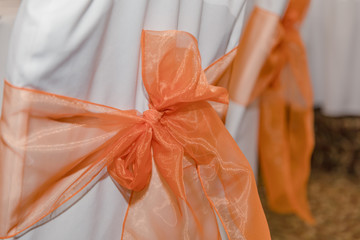 Canvas Print - Chair cover with orange ribbon