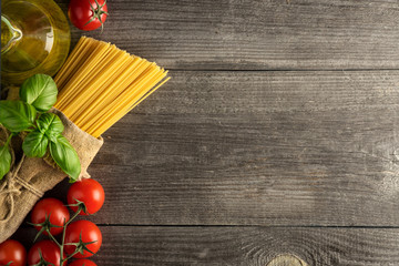 Italian pasta with tomatoes, basil and oil, top view