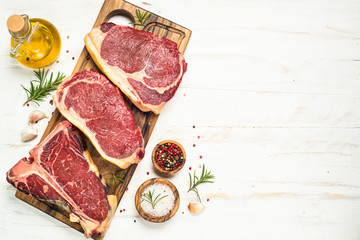 Wall Mural - Raw meat beef steak on white top view.