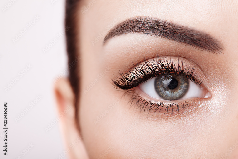 Female eye with long false eyelashes - obrazy, fototapety, plakaty 