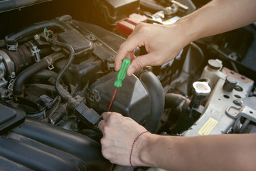 Car mechanic working with screwdriver in garage. Repair service.