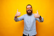 © Vulp - Smiling man in casual showing thumbs up gesture