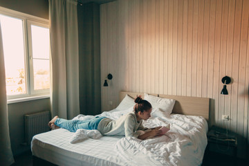 Canvas Print - Girl reading a book in bedroom