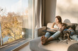 © ADDICTIVE STOCK - Embracing woman and girl on couch with dog