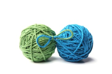 Wall Mural - two green and blue cotton thread balls tied in bow isolated on white background. different color gre