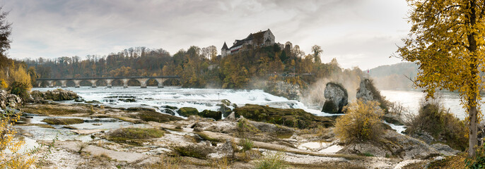 Poster - golden warm autumn colors Rhine Falls panorama landscape in Switzerland