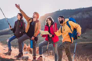 Poster - Group of hikers walking on a mountain at autumn day