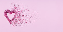 Glitter Heart Dissolving Into Pieces On Pink Background.  Valentines Day, Broken Heart And Love Emergence Concept