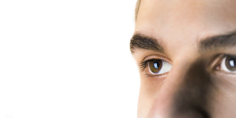 The eyes of the young man, a teenager. Close-up. Isolated on white background