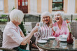 © Yakobchuk Olena - Waist up photo of old females resting in the cafe while having fun