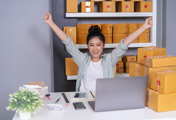 Wall Mural - successful woman entrepreneur with parcel boxes in her own job shopping online business at home office