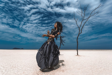 Wall Mural - Beautiful young stylish tribal dancer. Woman in oriental costume dancing outdoors