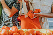 © Rawpixel.com - Friends buying fresh tomatoes at a farmers market
