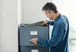 © StockPhotoPro - Clerk searching files