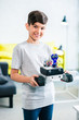 Optimistic smart boy holding his modern robot