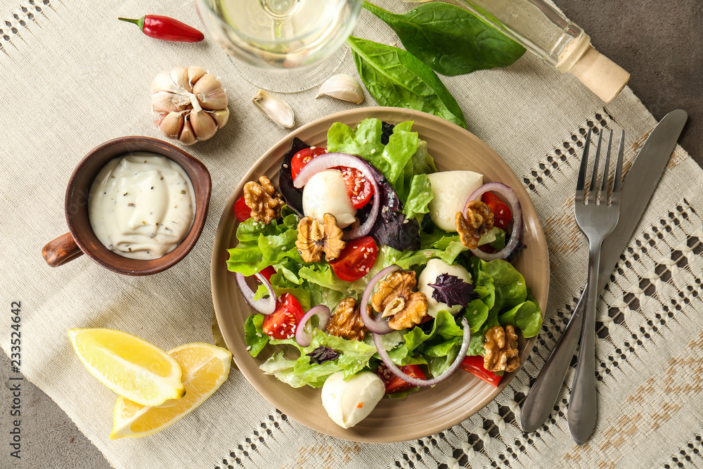 Delicious fresh salad with walnuts on plate