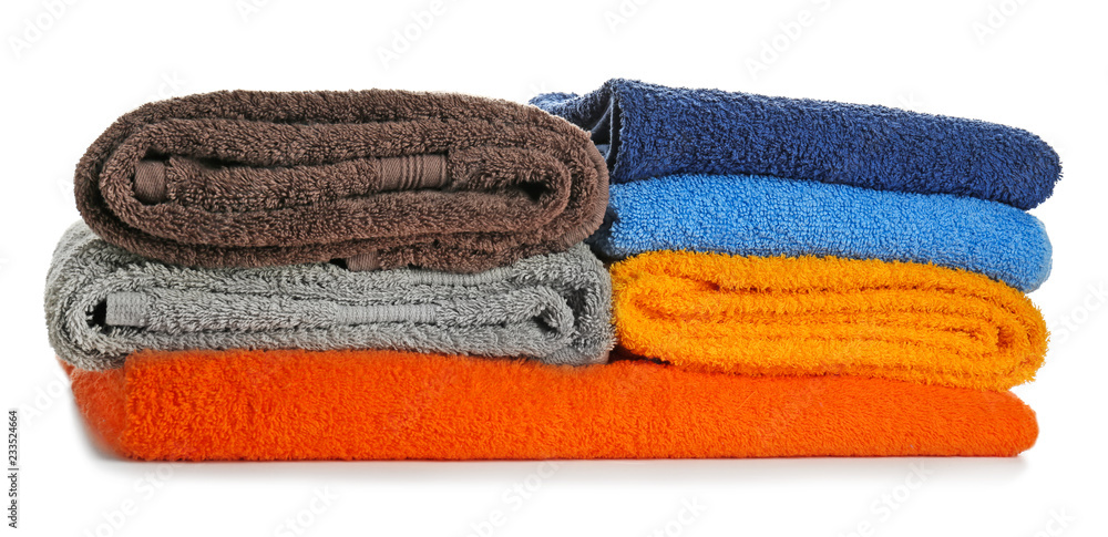 Stack of clean soft towels on white background