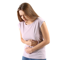 Wall Mural - Young woman suffering from abdominal pain on white background