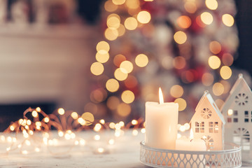 christmas decoration on a table over blurred lights
