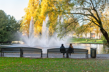 Two unidentified young women sitting in the park