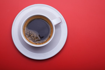 Cup of black coffee on table top view, flat lay, mock up. Cup of Black Coffee in White Ceramic Cup on plastic Tabletop