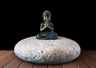 Ancient Buddha figurine on a stone