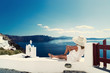 © Netfalls - Luxury travel vacation woman looking at view on Santorini island