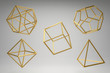Golden Platonic solids on a grey background. Dodecahedron, icosahedron, tetrahedron, octahedron, hexahedron.Abstract photorealistic 3d .
