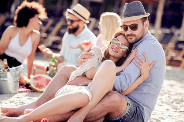 Sticker - Young couple enjoying picnic on beach together