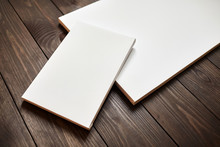 Two White Blank Canvases On Brown Wooden Background. Mockup