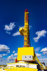 Wall Mural - new yellow drilling rig against the sky